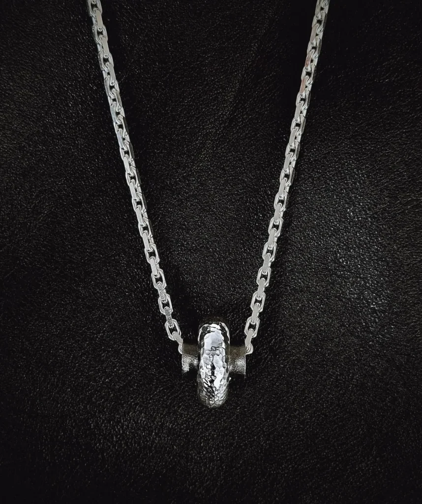 K.AND. hammered silver barrel pendant on a polished chain