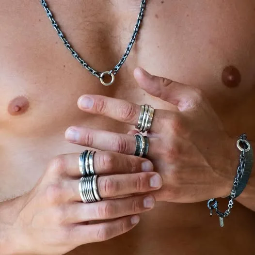 Man wearing K.AND. rings, bracelet and chain